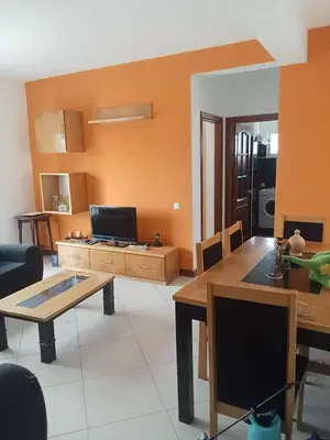 a living room with a table and a television at Gada House in Sal Rei