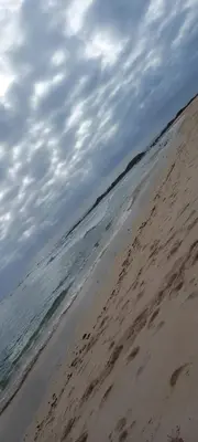 a person standing on a beach with the ocean at Gada House in Sal Rei