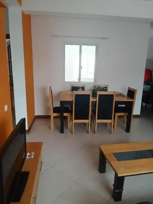 a dining room with a table and chairs and a window at Gada House in Sal Rei