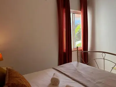 a bedroom with a bed and a window at Isabel s Bay in Santa Maria