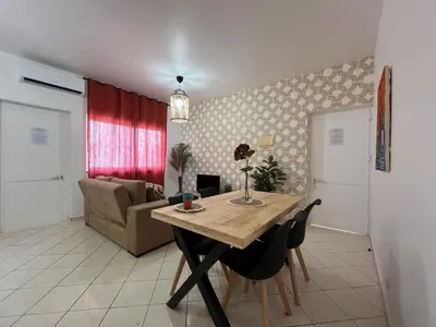 a living room with a table and a couch at Isabel s Bay in Santa Maria