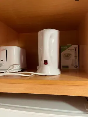 a white appliance sitting on a shelf next to a box at Isabel s Bay in Santa Maria