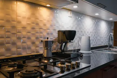 a kitchen with a coffee maker on a stove at Tabanka Azul - 2 BdR Cozy and Comfort Apt Near UN in Praia