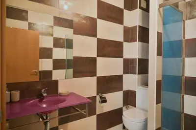 a bathroom with a sink and a toilet at Tabanka Azul - 2 BdR Cozy and Comfort Apt Near UN in Praia