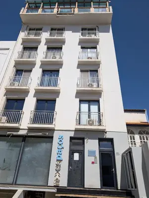 a white building with windows and balconies at Tabanka Azul - 2 BdR Cozy and Comfort Apt Near UN in Praia
