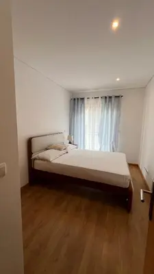a bedroom with a large bed and a window at Elson Apartment - T1 - Cidadela - Security, Comfort in Praia