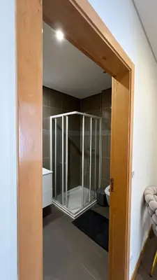 a bathroom with a glass shower in a room at Elson Apartment - T1 - Cidadela - Security, Comfort in Praia