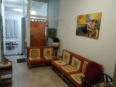 a living room with couches and a painting on the wall at Apartamento T3 em Alto Miramar in Mindelo