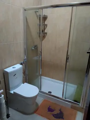 a bathroom with a shower with a toilet and a tub at Apartamento T3 em Alto Miramar in Mindelo