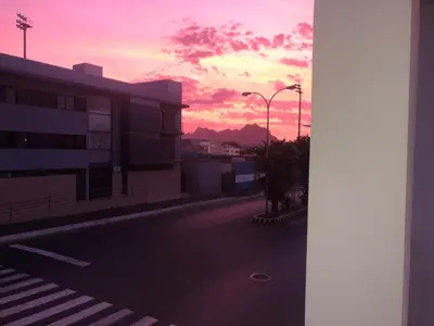 an empty city street with a sunset in the background at Casa Miranda in Mindelo