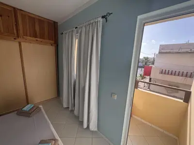 a room with a large window and a curtain at Holiday Properties Tropicana in Santa Maria