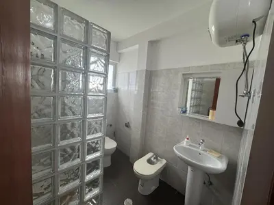 a bathroom with a white toilet and a sink at Holiday Properties Tropicana in Santa Maria