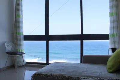 a bedroom with a large window looking at the ocean at Casa Nova in Ribeira Grande
