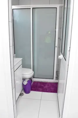 a bathroom with a toilet and a glass shower at Modern 2 bedroom apartment in Achada Santo António Praia'' Perto praca Di Nos