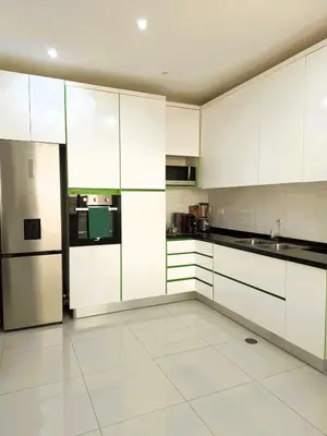 a large kitchen with white cabinets and appliances at Casa strella in Praia