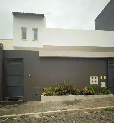 a building with a door and flowers in front of it at Casa strella in Praia