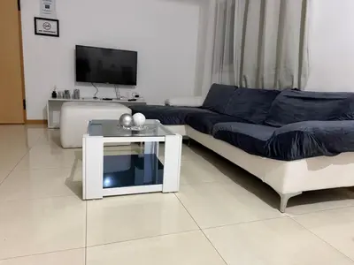 a living room with a couch and a table at Gamboa t2 in Praia