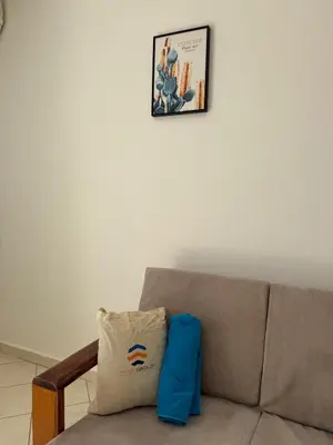 a couch with a pillow and a picture on the wall at Murdeira V159D Duplex by RPG Group in Beirona