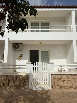 a white house with a white fence in front of it at Murdeira V159D Duplex by RPG Group in Beirona