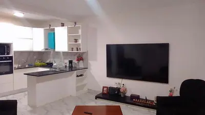 a living room with a large flat screen tv on the wall at Sal Blue Apartment in Santa Maria