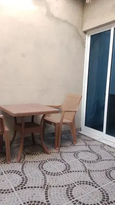 a patio with two benches and a table and chairs at Sal Blue Apartment in Santa Maria