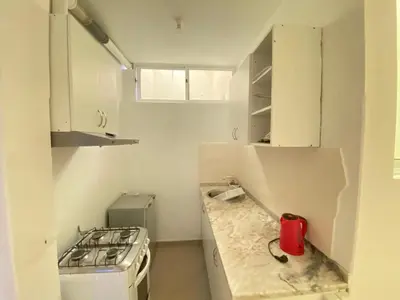 a kitchen with a stove and a counter top at Guest house B&S in Praia