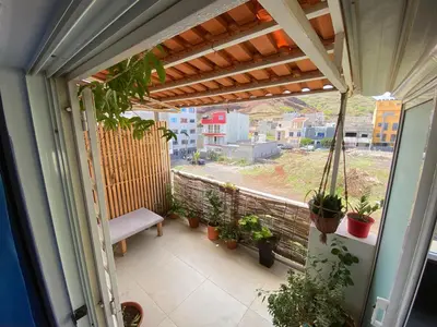 a balcony with a bench and potted plants on it at Guest house B&S in Praia