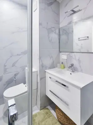 a white bathroom with a sink and a toilet at Sal Sol & Mar - Flor de Sal in Santa Maria