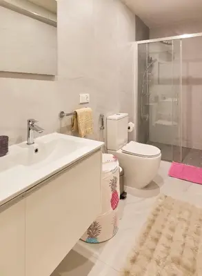 a white bathroom with a sink and a toilet at Sal Sol & Mar - Larimar in Santa Maria