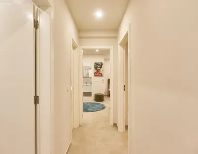 a hallway in a house with white walls and white floors at Sal Sol & Mar - Larimar in Santa Maria