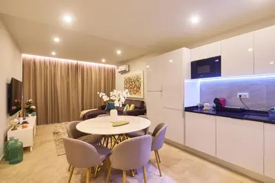a kitchen and living room with a table and chairs at Sal Sol & Mar - Larimar in Santa Maria