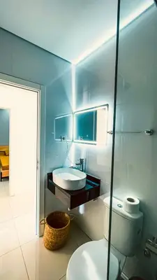 a bathroom with a white toilet and a sink at Prestige Apartment in Praia