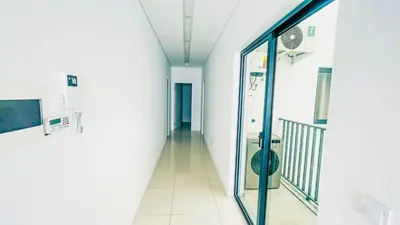an empty hallway in a hospital with a glass door at Prestige Apartment in Praia
