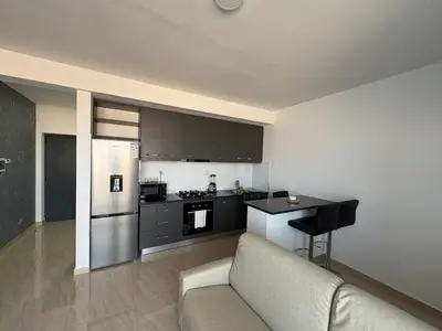 a living room with a couch and a kitchen at Apartamento Teixeira 2 in Espargos