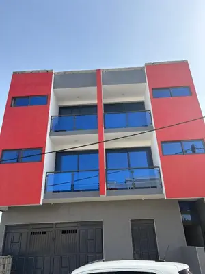 a red building with a car parked in front of it at Apartamento Teixeira 2 in Espargos