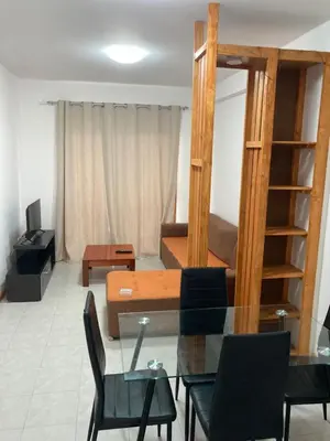 a living room with a table and a couch at Prédio IFH in Vila do Maio