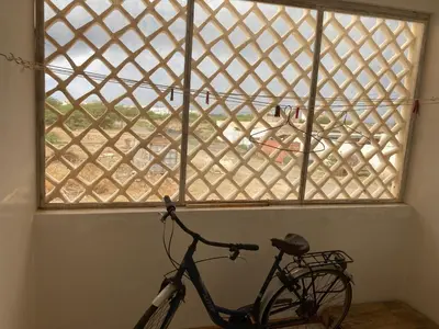 a bike parked in a room with a window at Prédio IFH in Vila do Maio