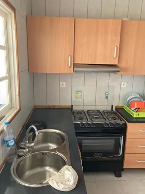 a kitchen with a sink and a stove at Prédio IFH in Vila do Maio