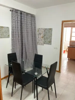 a dining room with a glass table and chairs at Prédio IFH in Vila do Maio