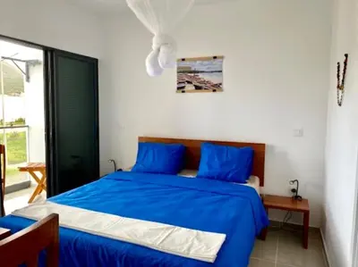 a bedroom with a blue bed in a room at Casa Uta in Tarrafal