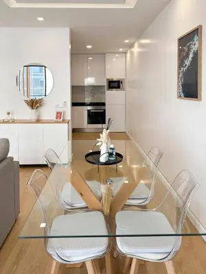 a glass table and chairs in a living room at Cozy 1-bdr apt, Cidadela - LCGR in Praia