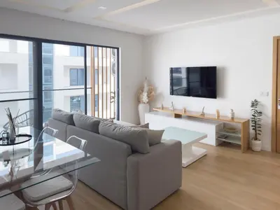 a living room with a couch and a table at Cozy 1-bdr apt, Cidadela - LCGR in Praia