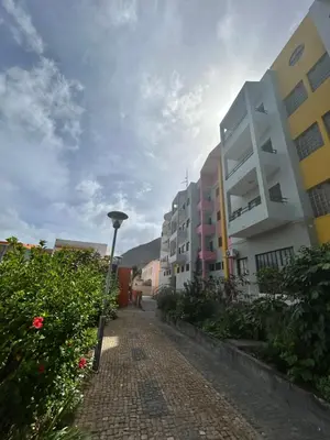 a cobblestone street with buildings and a street light at Apartamento Rua de Horta in Ribeira Grande