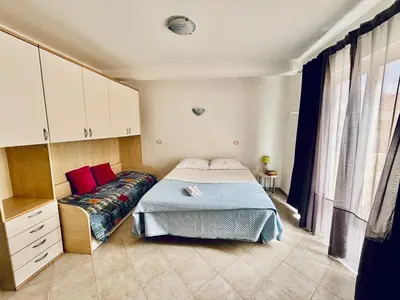 a bedroom with a bed and a couch at Flat 4U in Santa Maria