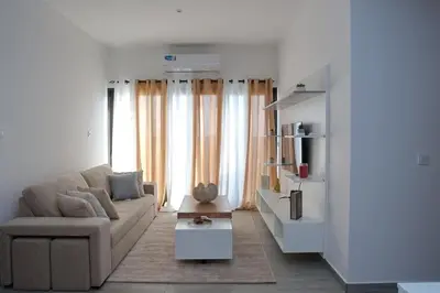 a living room with a couch and some windows at Comfort and Peace in Santa Maria