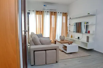 a living room with a chair and a table at Comfort and Peace in Santa Maria
