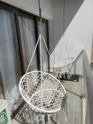 two white chairs are hanging from a porch at Comfort and Peace in Santa Maria