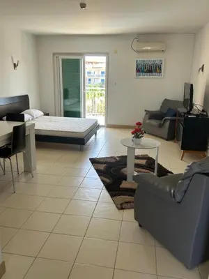 a living room with a couch and a table at Vila Verde House in Santa Maria