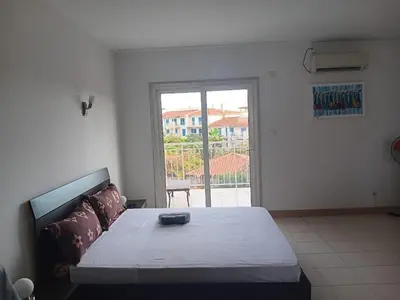 a bedroom with a large bed and a large window at Vila Verde House in Santa Maria