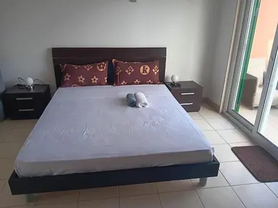 a stuffed animal laying on a bed in a bedroom at Vila Verde House in Santa Maria